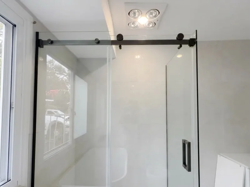 Sliding glass shower screen with black hardware in the First Glass gallery