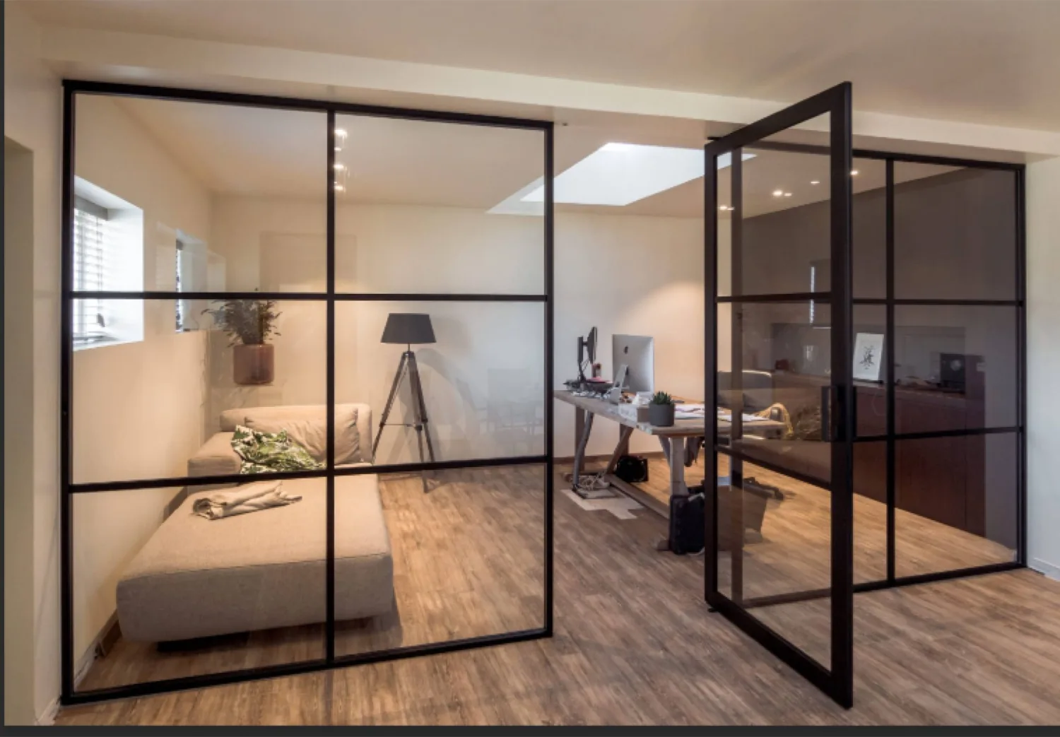 Black framed glass room divider between two living spaces