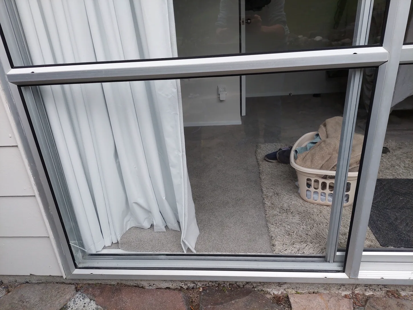 A sliding door with the glass out of the frame, open until replacement