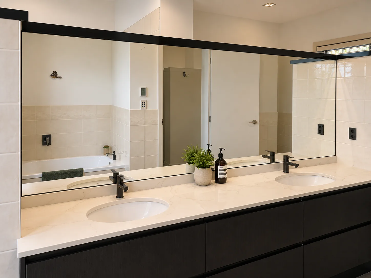 Bathroom mirror cut and fitted above a vanity