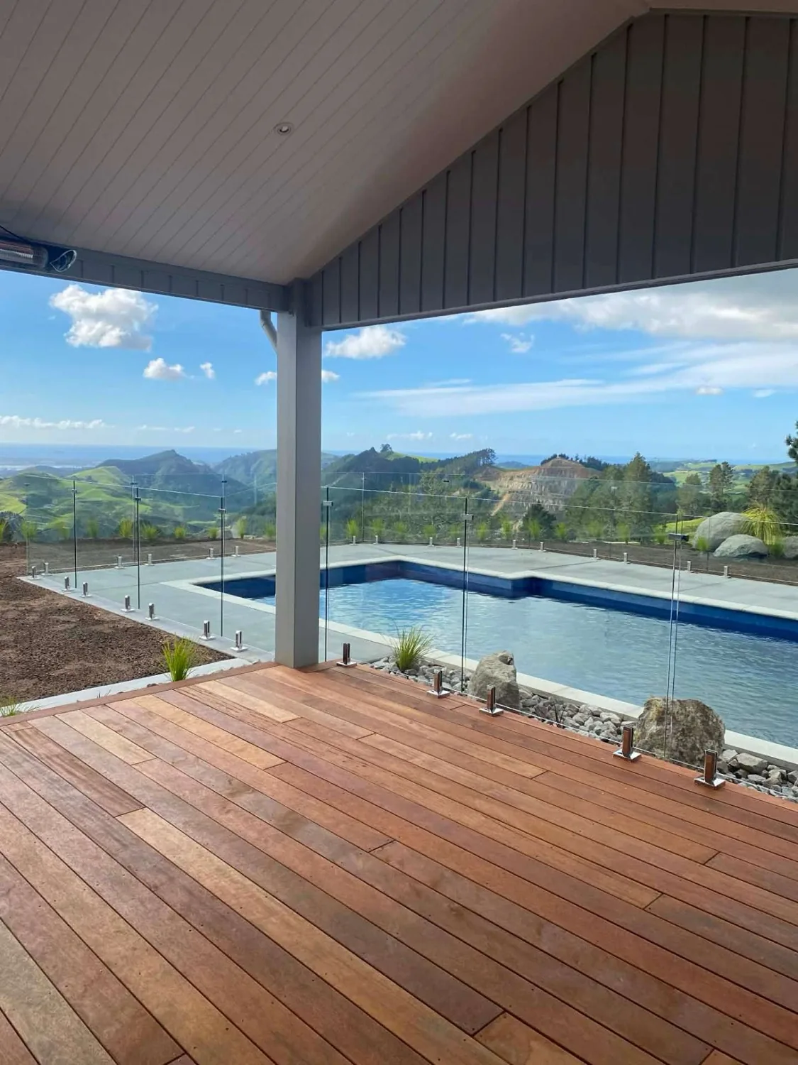 Glass pool fencing beside a timber deck